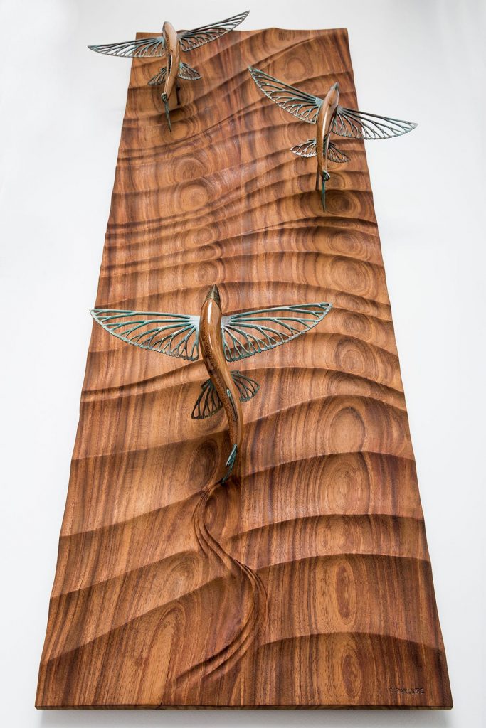 wood and bronze flying fish