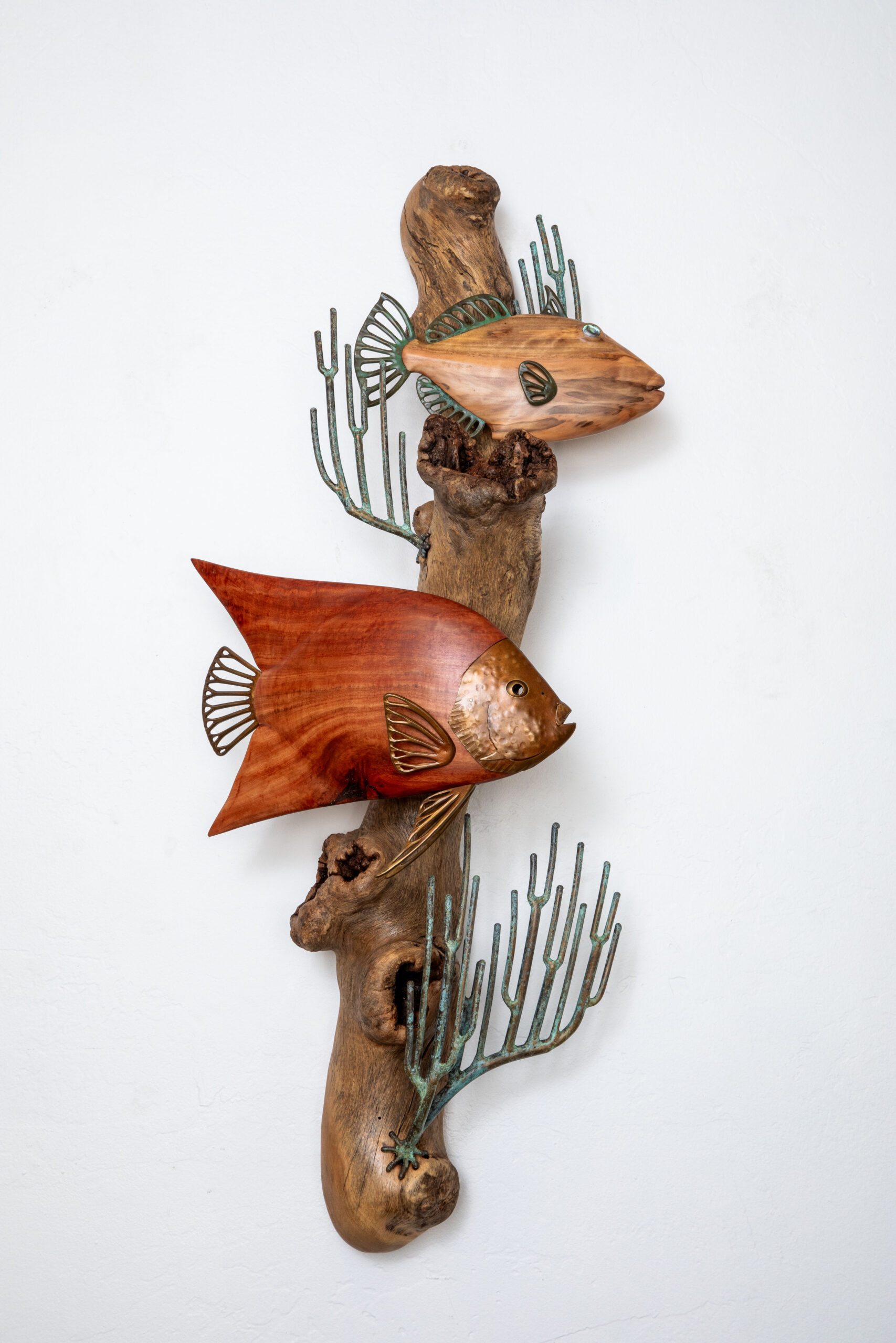 Carved wood and sculpted bronze sculpture of fish in reef