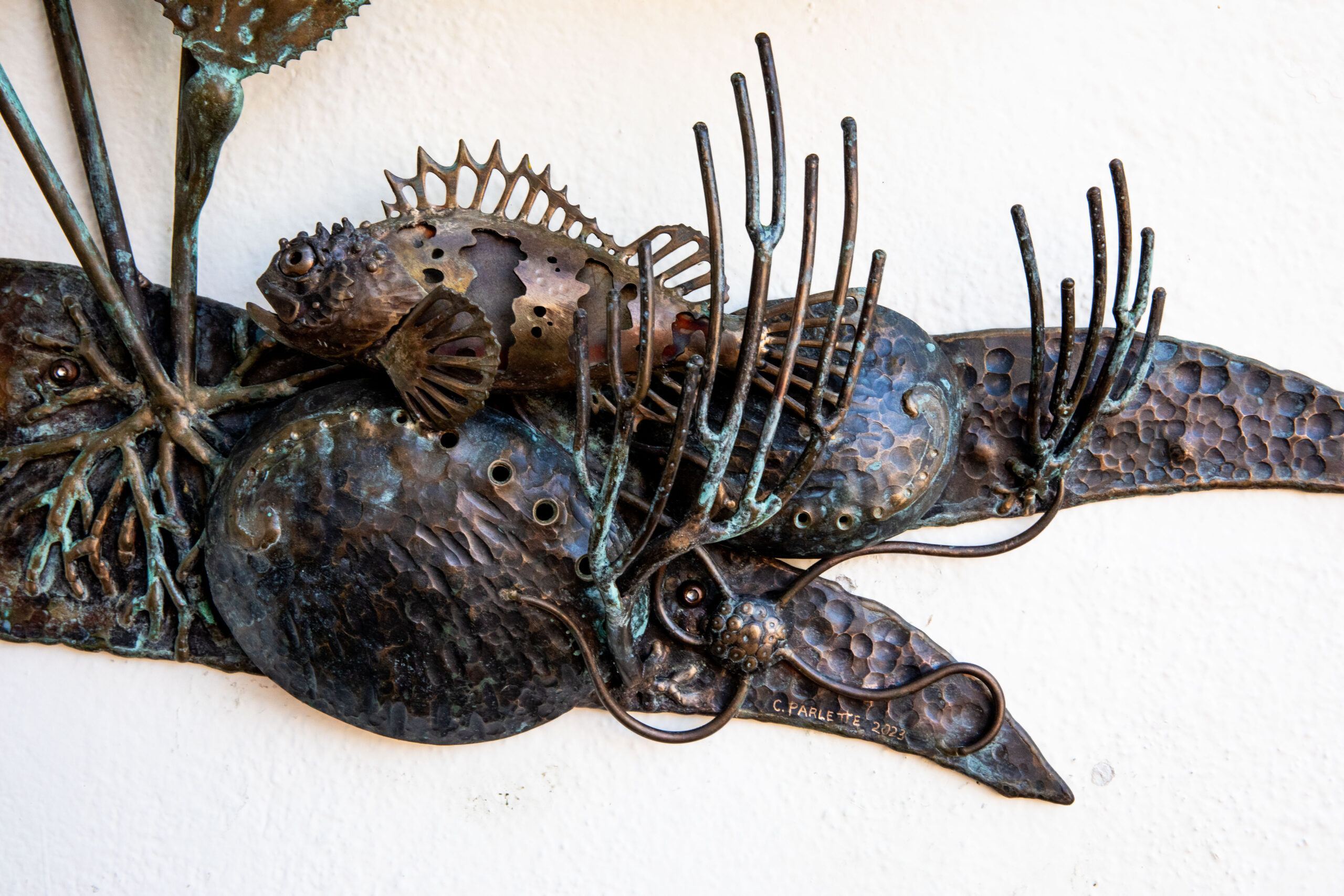 Hammered and welded bronze calico bass reef sculpture